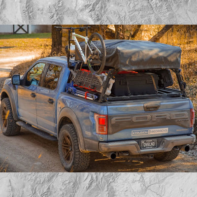 Ford Raptor Extrusion Overland Bed Rack with Hi-lift mounted, Rotopaxs mounted, Molle panels, Mountain Bike, Roof top tent, and Pressurized solar water tank.